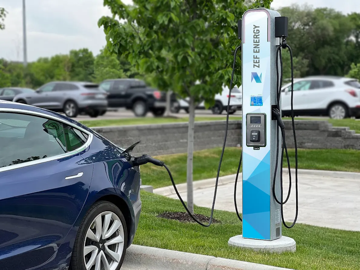A ZEF Energy DC fast charger with a vehicle plugged in and charging